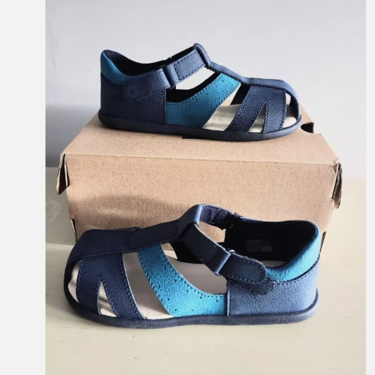 These Ugg Kylo Sandals Are Perfect For Your Little One's Summer Adventures. With A Marine Brown Color And Synthetic Upper Material, They Are Both Stylish And Durable. The Sandals Are Designed For Unisex Babies And Toddlers, And Come In A Uk Shoe Size Of 10 And Us Shoe Size Of 11t. The Kylo Sandals Feature A Comfortable Fit And A Secure Strap, Ensuring That Your Child Can Play And Explore Without Any Issues. Whether They Are Headed To The Beach Or Just Out For A Walk, These Sandals Are A Must-Hav Blue Closed Toe Sandals With Soft Sole, Blue Sandals With Soft Sole For Spring, Spring Blue Sandals With Soft Sole, Casual Adjustable Blue Sandals, Casual Blue Adjustable Sandals, Blue Closed Toe Sandals For Playtime, Outdoor Sandals With Soft Sole And Round Toe, Non-slip Adjustable Fit Round Toe Sandals, Blue Sandals With Soft Sole For Playtime