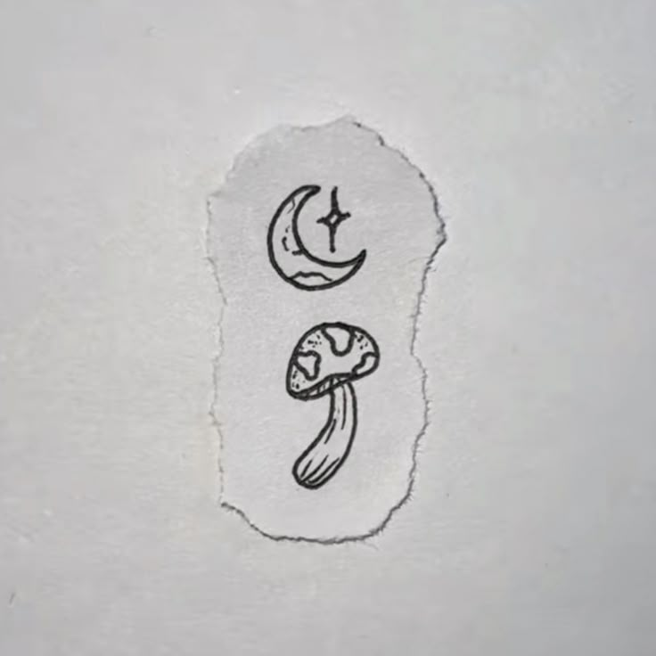 a piece of paper with an image of a mushroom and crescent moon on the side