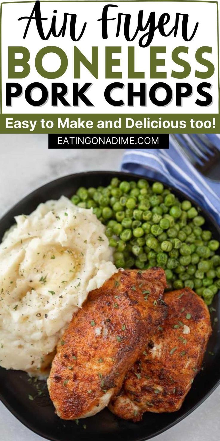 a black plate with mashed potatoes, peas and fried pork chops on it