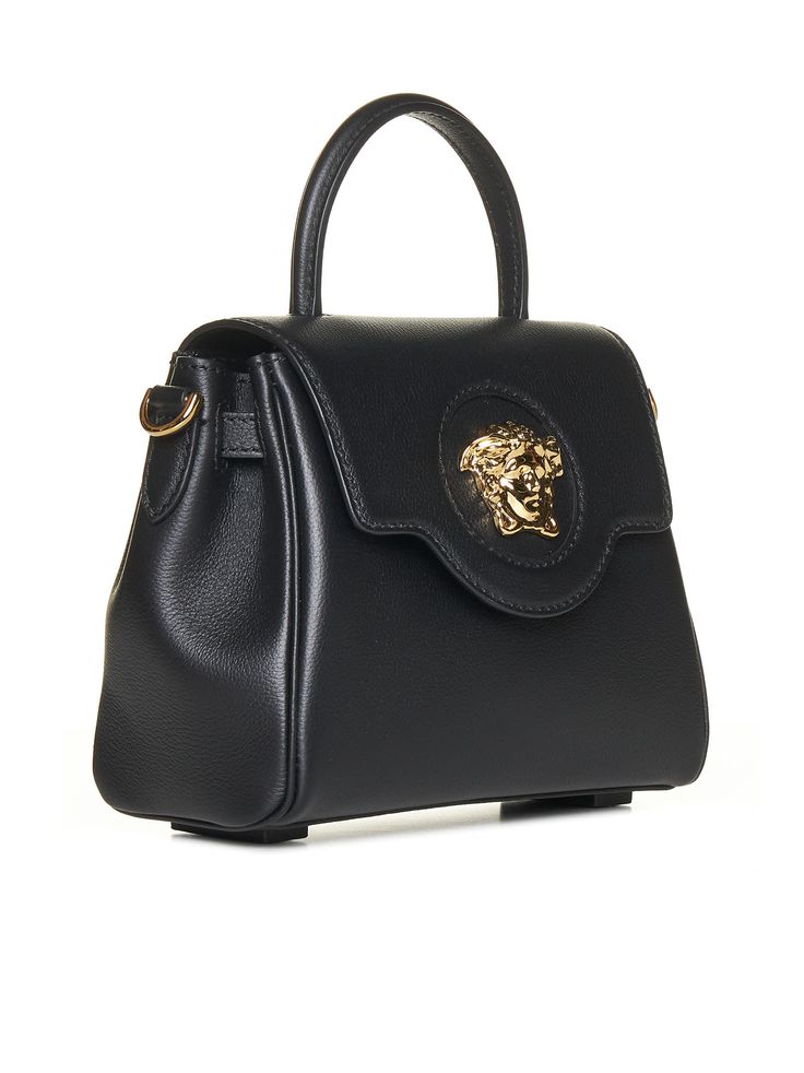 100% calf leather - Flap top magnetic snap closure - One handle - Detachable shoulder strap - Gold tone logo plaque - Length 20 cm / 7,8 in - Height 17 cm / 6,7 in Black Versace Bag, Luxury Rectangular Shoulder Bag With Logo Plaque, Designer Crossbody Bag With Logo Hardware, Luxury Shoulder Bag With Logo Plaque And Top Handle, Luxury Shoulder Bag With Top Handle And Logo Plaque, Luxury Shoulder Bag With Logo Plaque For Business, Black Evening Bag With Logo Plaque, Designer Crossbody Shoulder Bag With Logo Plaque, Formal Crossbody Shoulder Bag With Logo Plaque