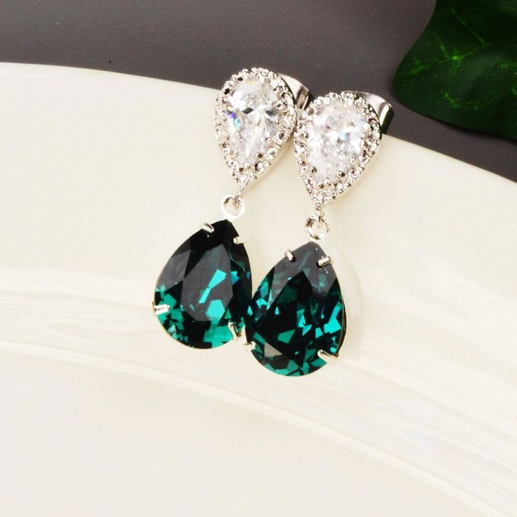 "The color is radiant in this pair of emerald green earrings. The sparkling earrings have a rich shade of emerald green teardrop that is attached to a rhodium plated cubic zirconia pear with sterling silver ear posts. The cubic zirconia earrings are perfect for any special occasion and beautiful enough to be worn by the bride and her bridesmaids. The emerald earrings measure 1 1/4\". Multiples available at checkout with discounted pricing for your bridesmaids gifts. Message me if you don't see t Elegant Crystal Earrings For May Birthstone Party, Elegant May Birthstone Crystal Earrings For Party, Elegant Green Crystal Earrings For Pierced Ears, Green Crystal Earrings For Pierced Ears, Elegant Green Teardrop Crystal Earrings, Elegant Green Emerald Earrings, Formal May Birthstone Crystal Drop Earrings, Elegant Emerald Crystal Earrings For Party, Elegant Green Crystal Earrings For Weddings