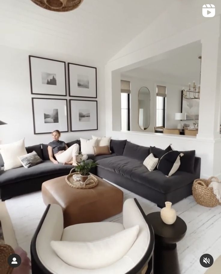 a living room filled with furniture and pictures on the wall