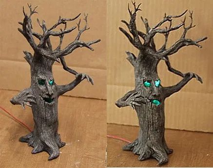 two pictures of the same tree with green eyes and leaves on it, one is made out of metal