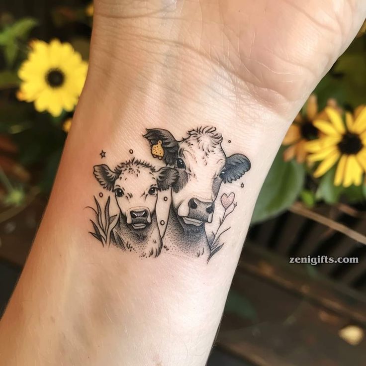 two cows with flowers on their wrist tattoo by zeenglits com tattoos and body art