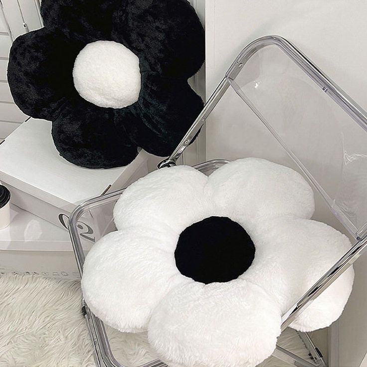 two black and white pillows sitting on top of a chair