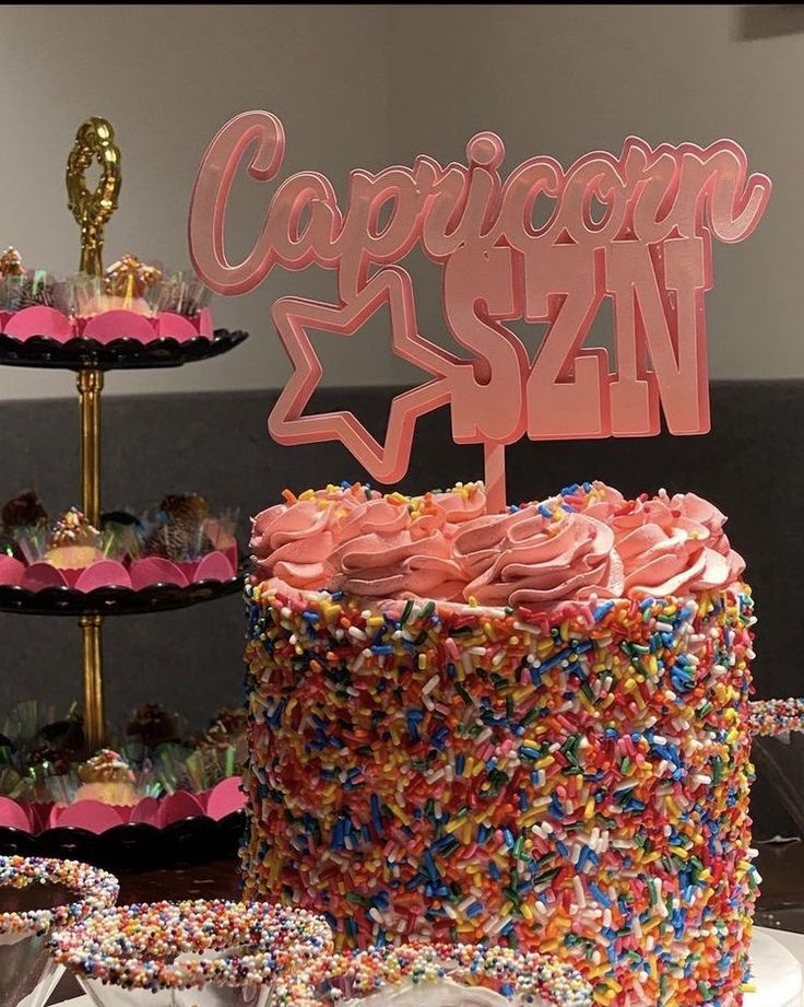 there is a cake with sprinkles on it and a sign that says capitol san