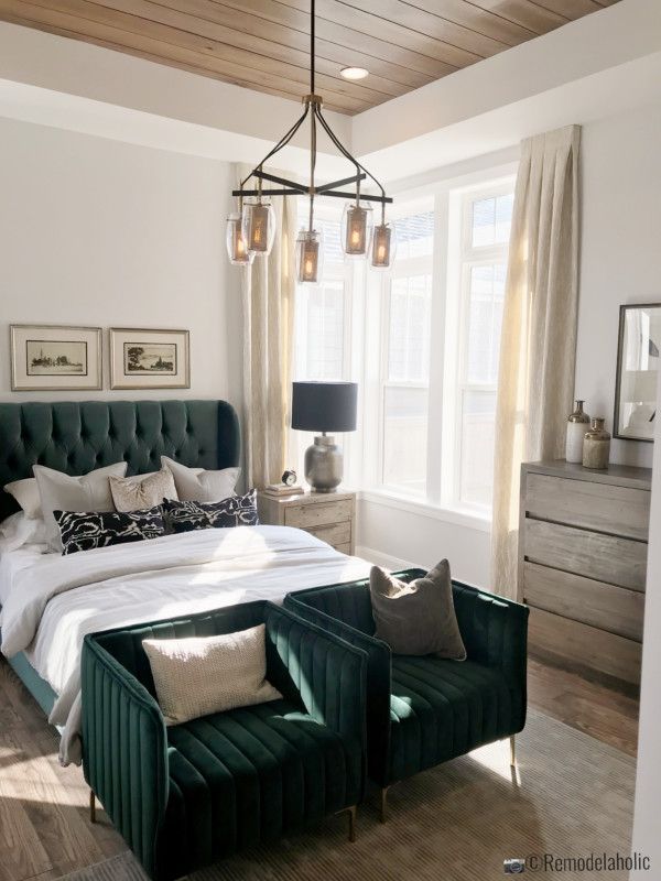 a bedroom with white walls and green furniture