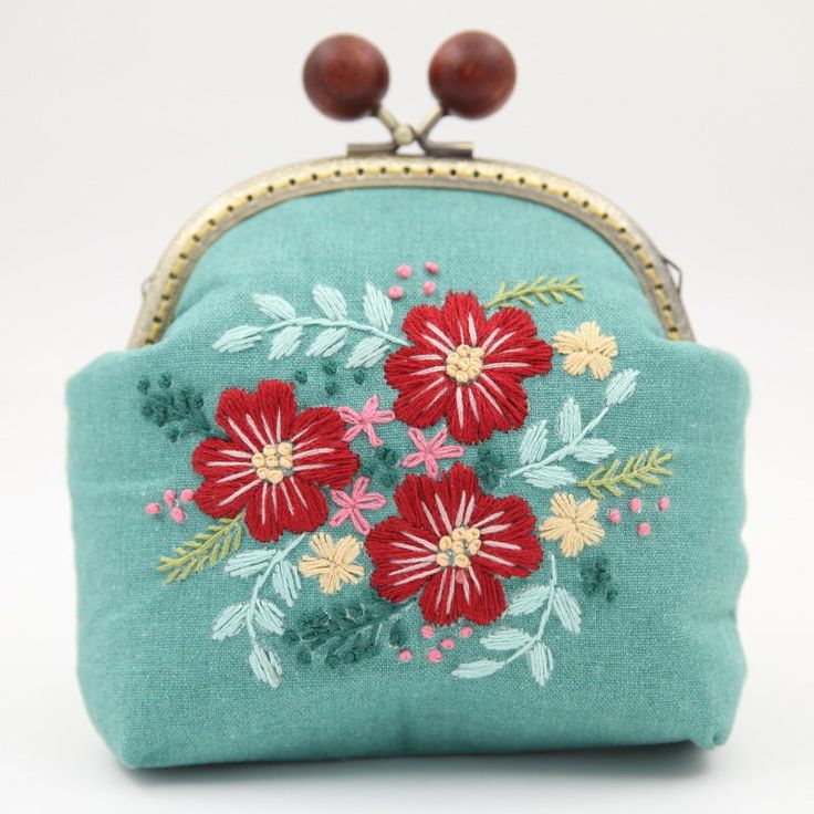 Embroidery Flowers Handbag Elevate your style with our exquisite Embroidery Flowers Handbag. This beautifully crafted accessory showcases a stunning floral design meticulously embroidered onto a high-quality fabric, creating a unique and elegant look. With ample space and a convenient shoulder strap, this handbag effortlessly combines fashion and functionality. Make a statement and carry a piece of art with you wherever you go. Blue Embroidered Rectangular Pouch, Green Bags With Floral Embroidery As A Gift, Blue Bags With Floral Embroidery For Daily Use, Daily Use Blue Bags With Floral Embroidery, Embroidered Blue Pouch As Gift, Embroidered Blue Pouch For Gifts, Blue Floral Embroidery Bag For Everyday Use, Blue Embroidered Pouch For Gifts, Blue Floral Embroidery Bags For Everyday Use