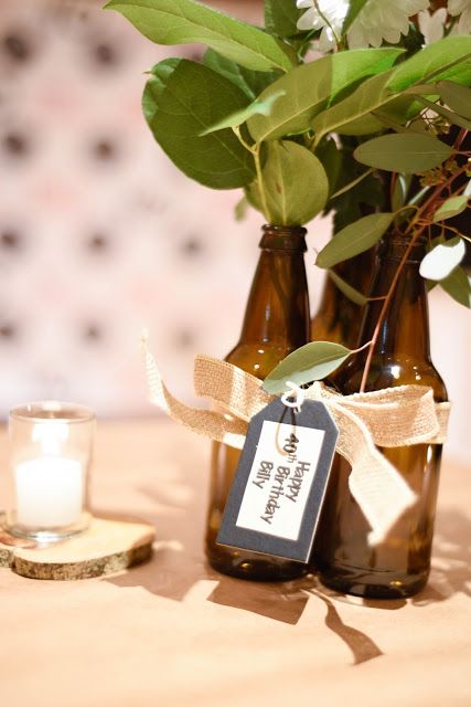 two brown vases with flowers in them and a label on the top that says welcome