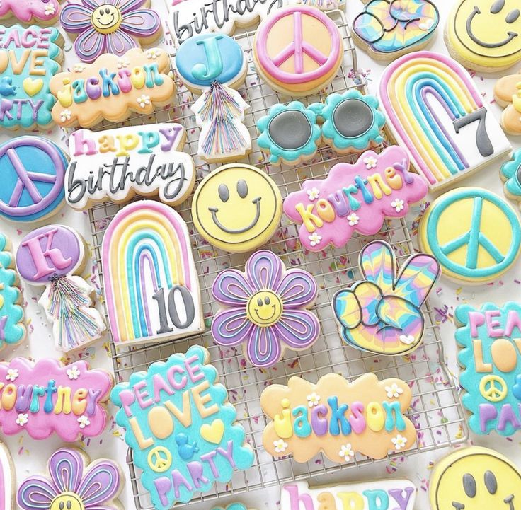 decorated cookies with happy birthday messages and smiley faces are displayed on cooling racks in front of a white background