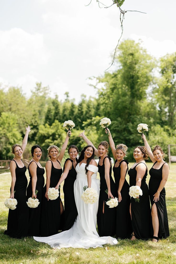 a group of women standing next to each other on top of a lush green field