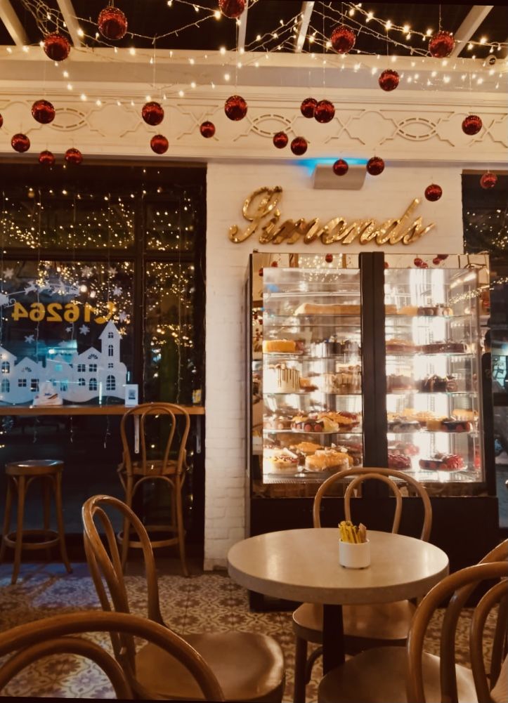 the inside of a bakery with lots of lights