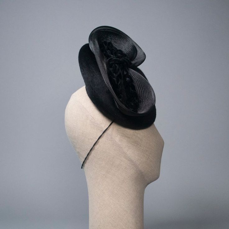 Festive fascinator in luxe black melusine-finish fur felt with braided velvet and crinoline trims. Materials: Ethically sourced fur felt, Velvet, Crinoline, Millinery Wire, Grosgrain Style: Fascinator Attachment: Elastic Measurements: 9 in diameter base Hat Box: 10 in How to Wear: Worn on right side of head Ready to Ship. This piece is available in custom colors.Please read FAQ's & Shop Policies before purchasing.Any other questions? Click here to contact me. Each Milli Starr piece is meticulous Black Fitted Fascinator For Evening, Fitted Black Fascinator For Evening, Fitted Black Headpiece For Evening, Fitted Black Fascinator With Feather Trim, Elegant Black Feather Trim Costume Hat, Fitted Black Headpiece For Royal Ascot, Elegant Black Costume Hat With Feather Trim, Elegant Black Fascinator With Feather Trim, Black Top Hat For Evening With Structured Crown