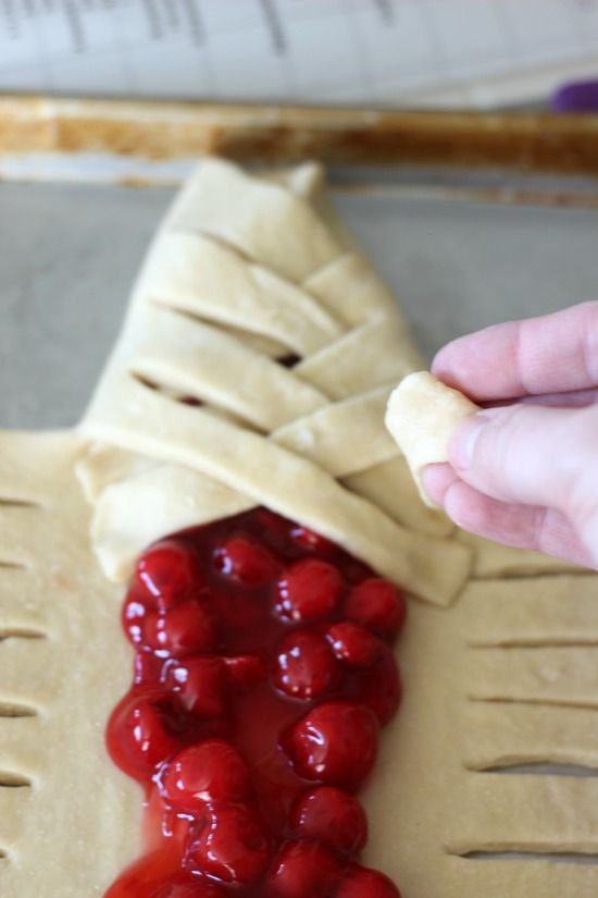 This delicious cherry-filled candy cane braided bread is drizzled with a sweet vanilla icing! It's the perfect treat for the holidays. Braided Bread Recipe, Christmas Loaf, Braided Pie Crust, Cherry Christmas, Filled Candy, Homemade Croissants, Baked Dessert, Alphabet Cookies, Xmas Treats