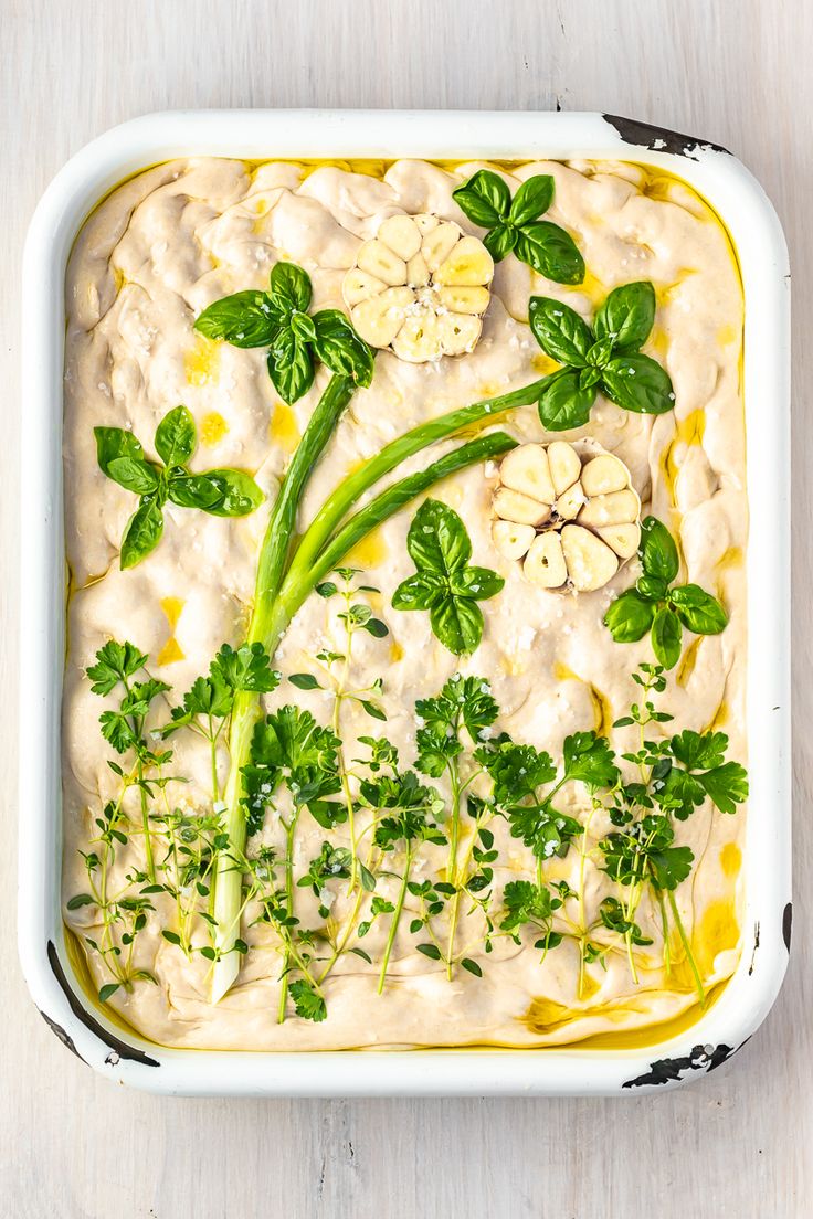 a casserole dish with green vegetables and cream sauce