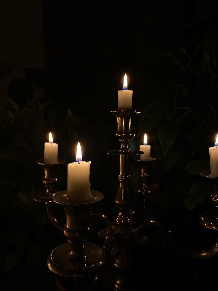 a group of lit candles sitting on top of a table