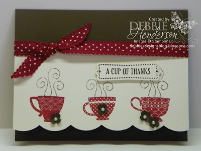 a close up of a card with coffee mugs on it and a red ribbon