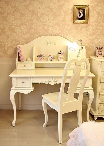 a white desk and chair in a room with pink wallpaper on the walls behind it