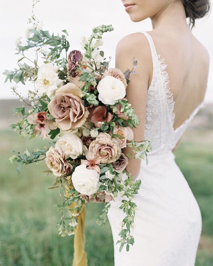 a woman holding a bouquet of flowers in her hand on the instagramture page