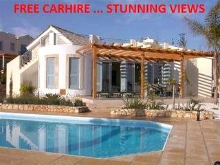 an empty swimming pool in front of a house