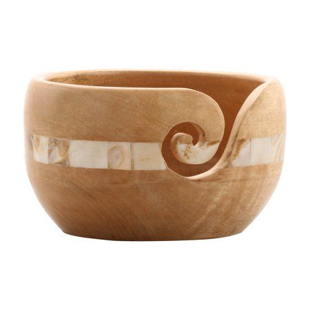 a wooden bowl with swirl designs on it