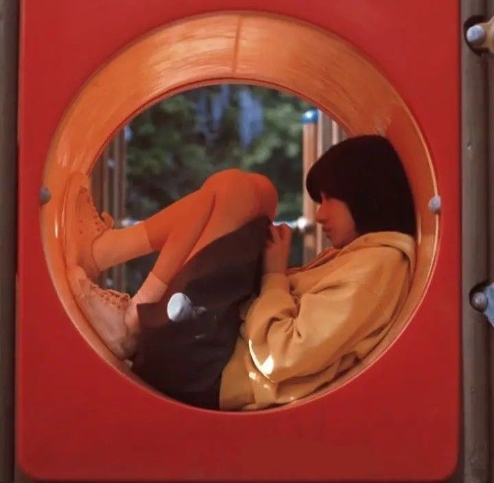 a woman laying down in a play area