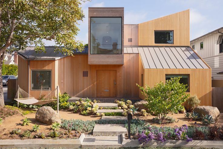 the house is made out of wood and has many windows