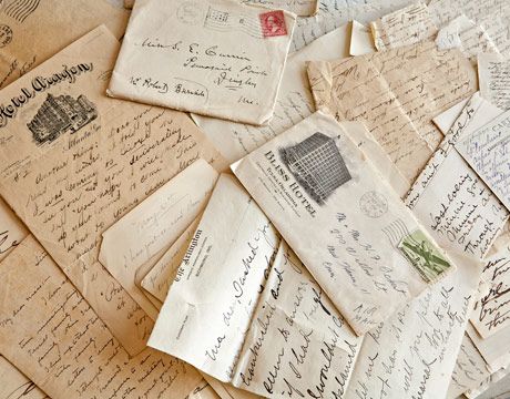 many old letters and envelopes are scattered on the floor