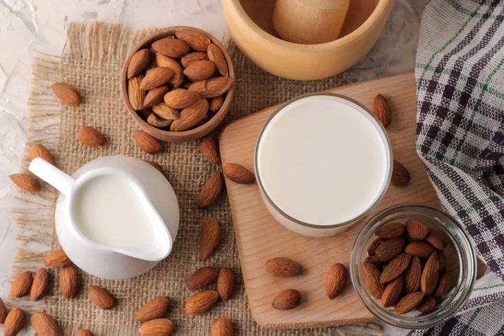 almonds and milk are sitting on a table