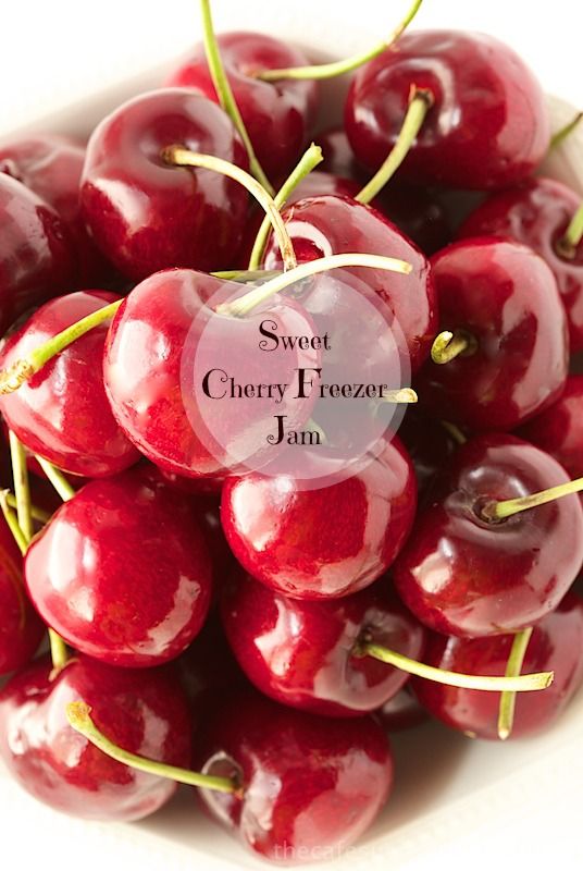 a white bowl filled with lots of red cherries