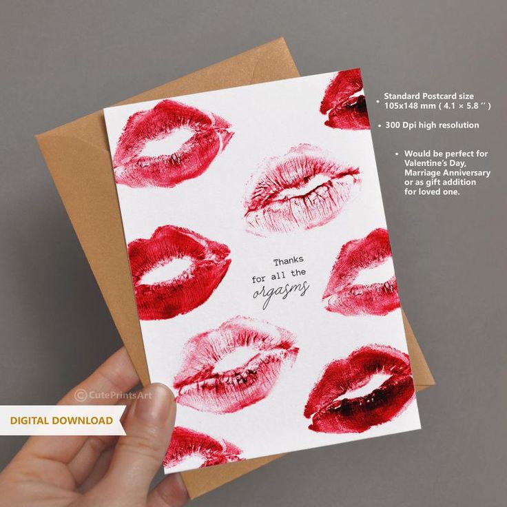 a hand holding up a card with red lipstick on it