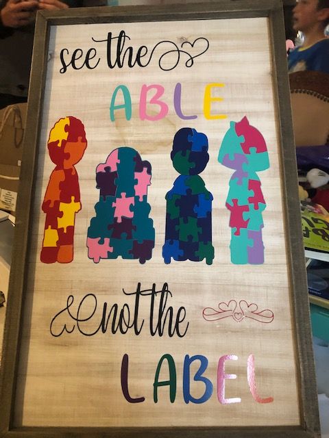 a wooden sign that says see the able and not the labeled people in puzzle pieces