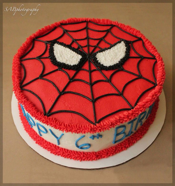 a birthday cake with a spiderman face on it