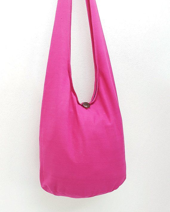 a pink purse hanging on a white wall