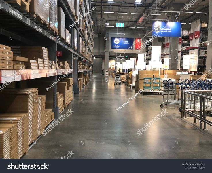 an empty warehouse filled with boxes and carts