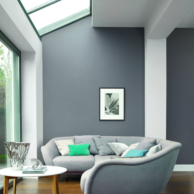 a living room filled with furniture and a skylight