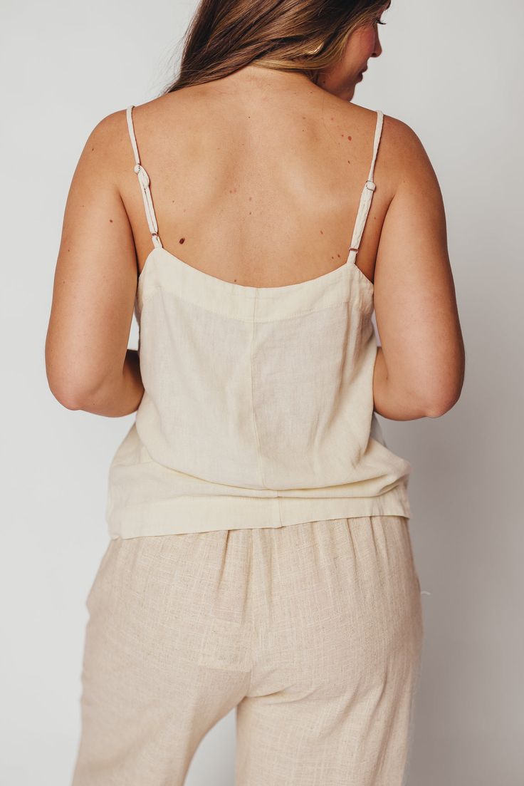 Whether you're on your way to sun-kissed beaches, picking up some things at the farmer's market, or stopping by your favorite coffee shop, you'll want to be wearing the Mello Tank. This is the easiest top we've curated this season -- it's breezy, chic, and completely feminine without any frills. Pair with denim, linen, or a slinky satin midi skirt. FIT: Runs true to size. MATERIAL: 55% Linen, 45% Rayon. GARMENT DETAILS: Lightweight camisole tank with square neckline, adjustable spaghetti straps, and relaxed fit. No lining. SIZE GUIDE: XS (0-2) / S (2-4) / M (6-8) / L (10-12) / XL (14-16) MODEL DETAILS: MISSES Mackenzie - Size S Heather - Size S Bust 34" 34" Waist 27.5" 27.5" Hips 40.5" 37.5" Height 5'7" 5'7" Spring Tops With Adjustable Straps For Day Out, Casual Tops With Adjustable Straps For Spring, Casual Spring Tops With Adjustable Straps, Spring Vacation Tops With Adjustable Straps, Summer Tops With Adjustable Straps For Day Out, Summer Beachwear Camisole With Spaghetti Straps, Summer Tank Top For Vacation, Adjustable Strap Tops For Beach Season, Adjustable Strap Tops For Beach Season Day Out