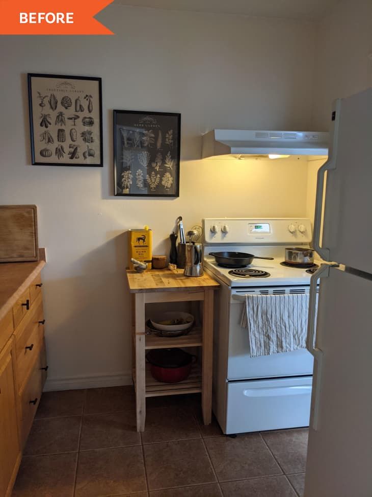 a small kitchen with an oven, refrigerator and sink in it's center area