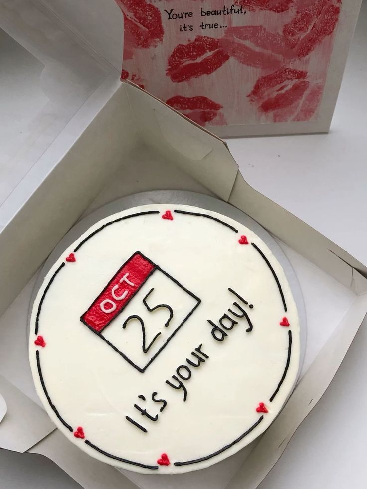 a birthday cake in a box with the number 25 on it