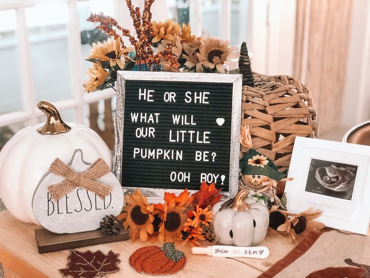 there is a sign that says he or she what will our little pumpkin be?