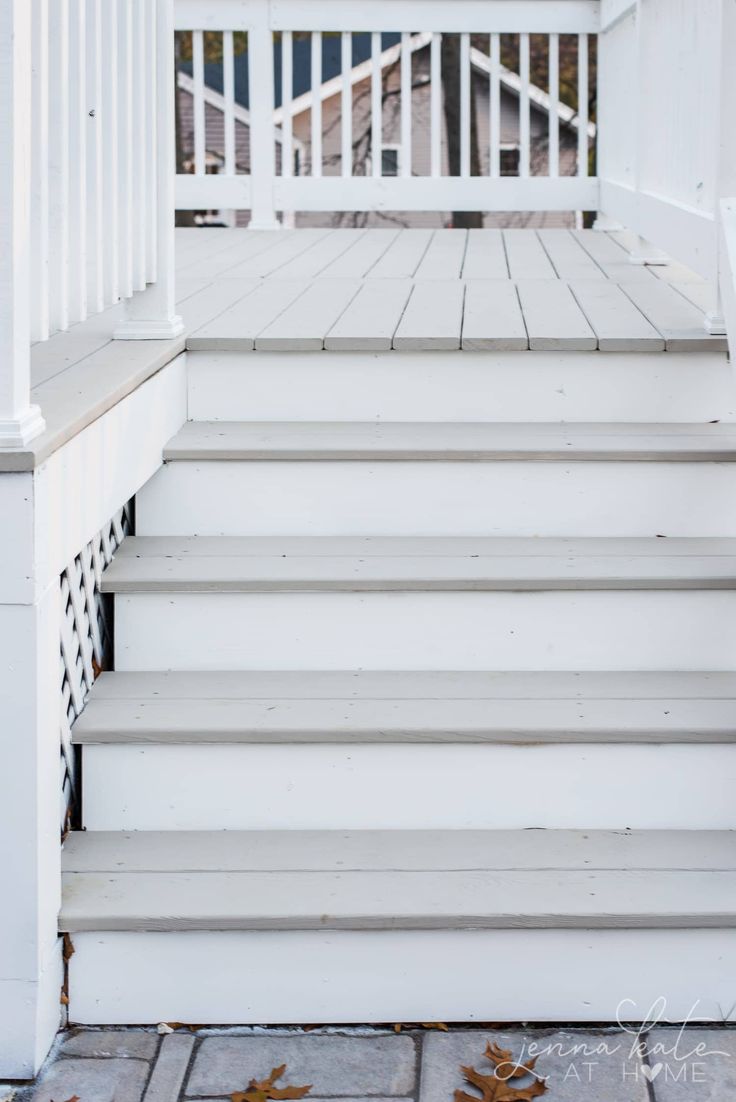 steps leading up to the front door of a white house