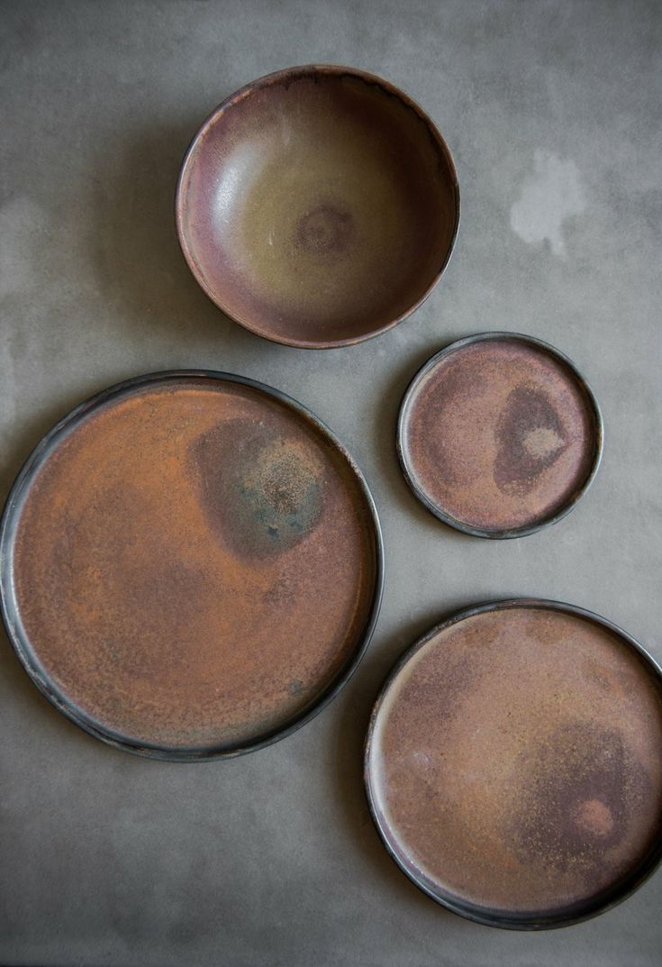 three brown plates sitting on top of a table