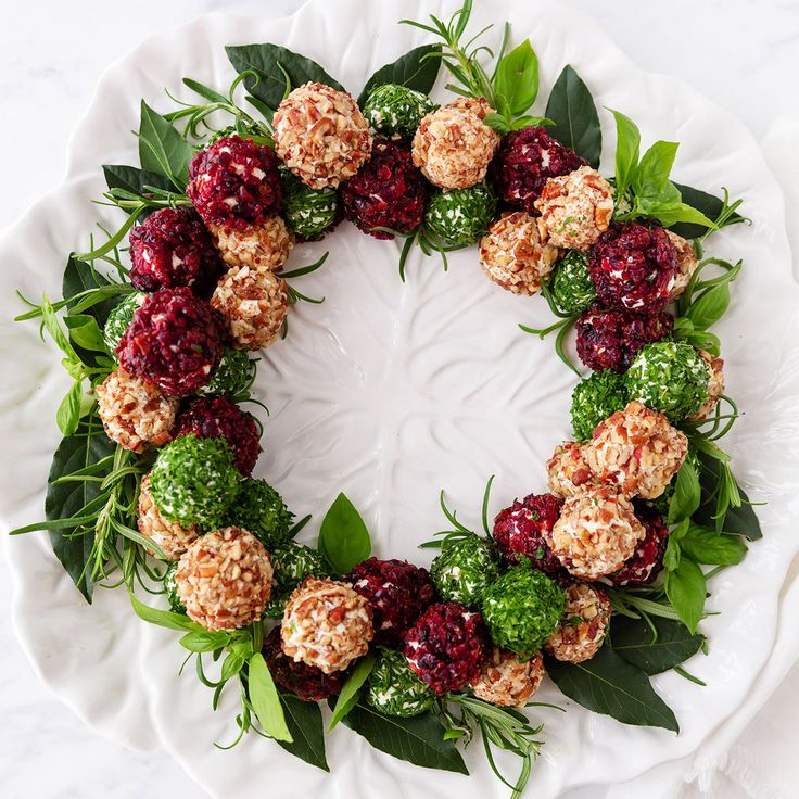 a white plate topped with fruit and veggies on top of green leafy leaves