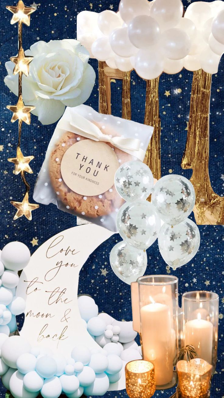 a table topped with lots of white and gold decorations on top of a blue surface