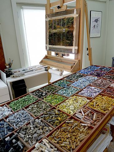 an artist's easel filled with lots of different colored rocks