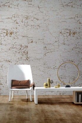 a white chair sitting next to a table on top of a hard wood floor in front of a wall