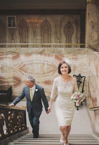 the bride and groom are walking down the stairs