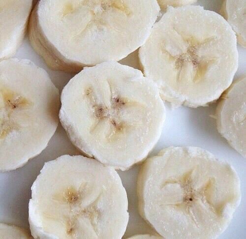 sliced bananas are arranged on a white plate