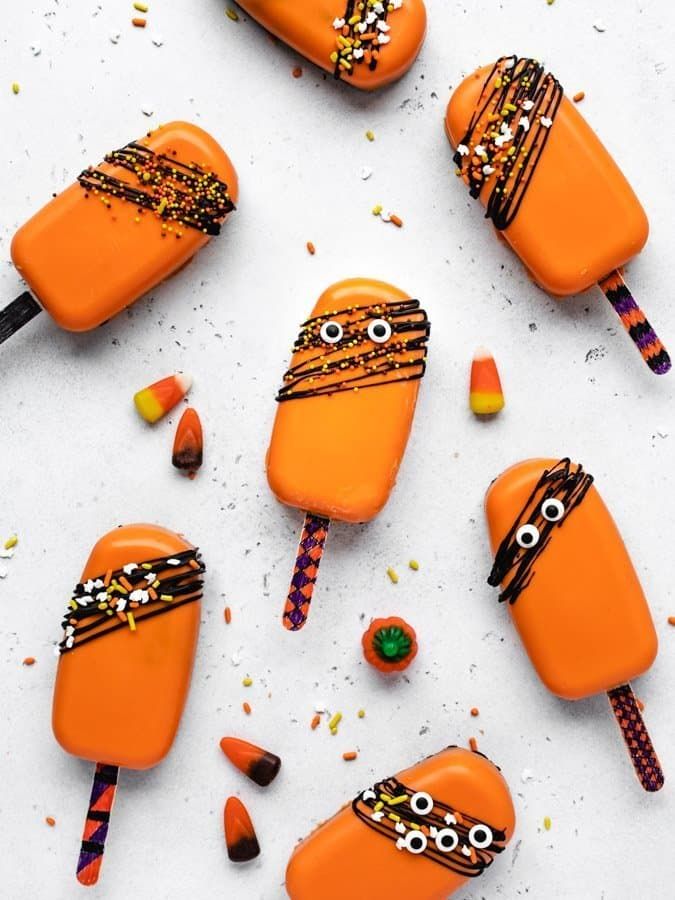 candy pops decorated with halloween decorations and eyes