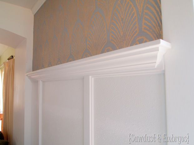 the corner of a room with white trim and wall paper